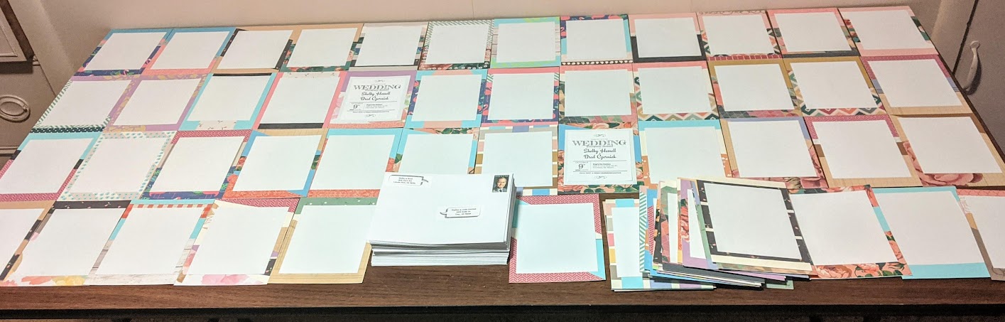 A larger quantity of more-complete wedding invitations on a table